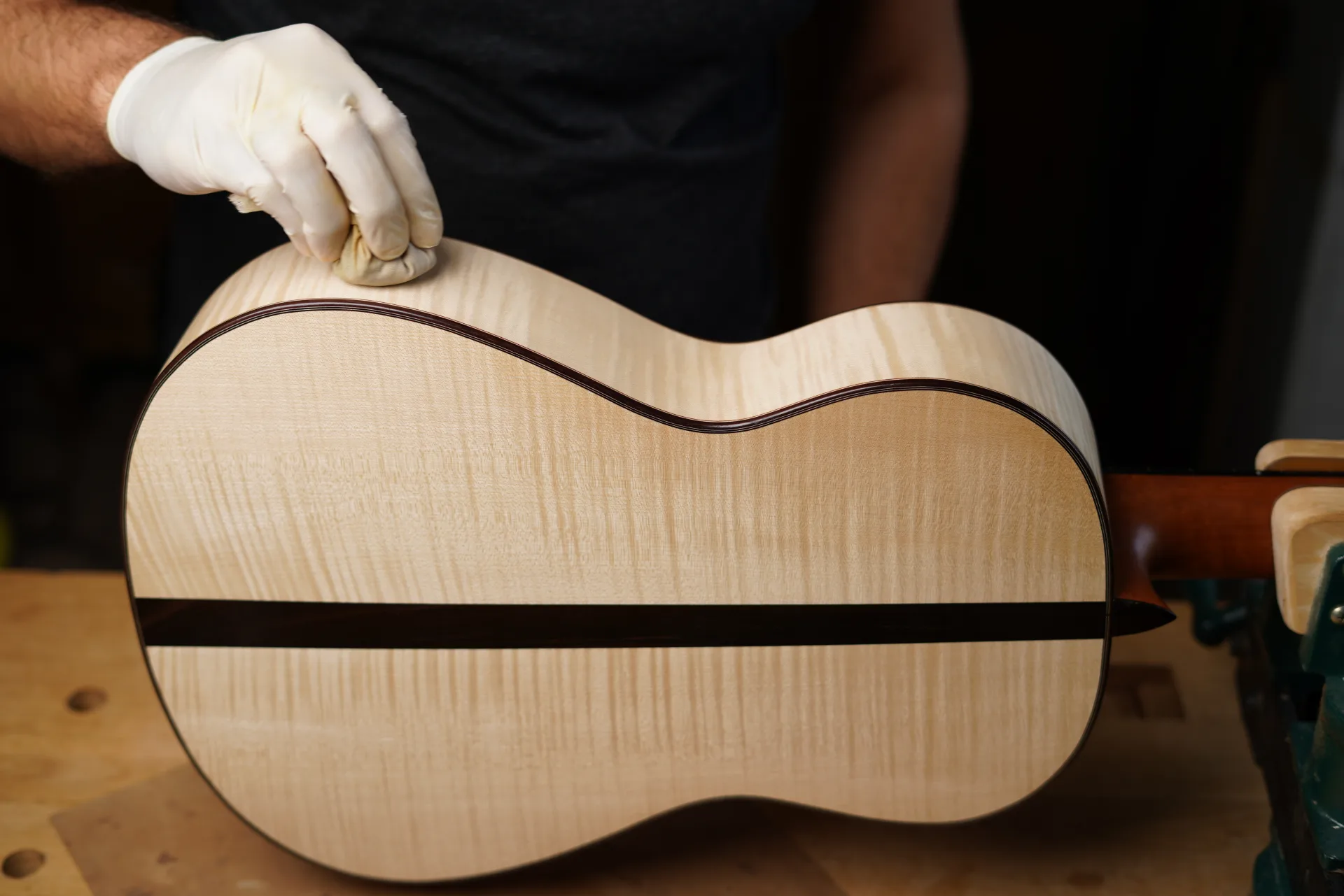 A cloth lightly soaked in shellac passed over the purflings to fix the colours before the first coats