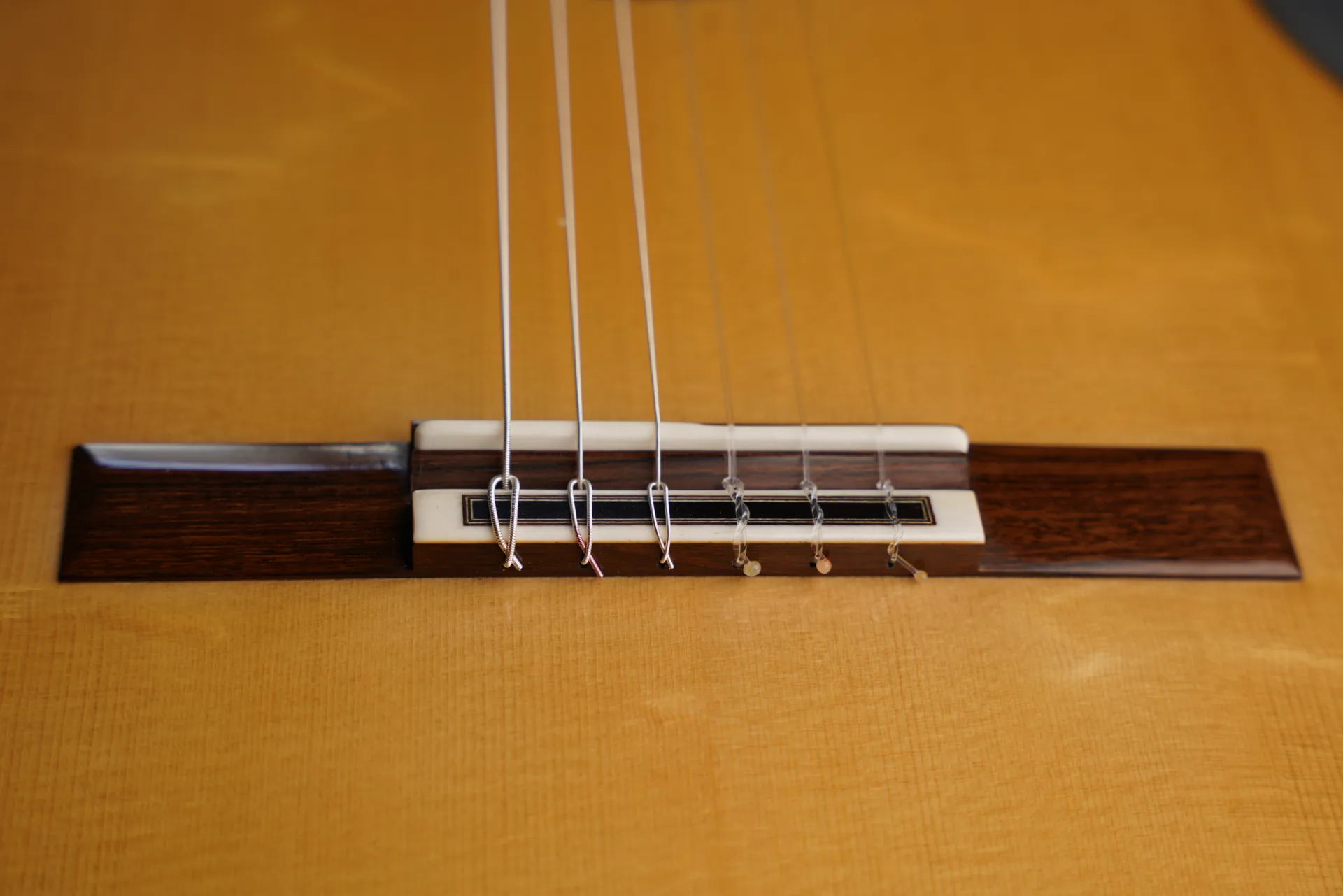 A single loop is sufficient for bass strings — a second loop can be added for extra security