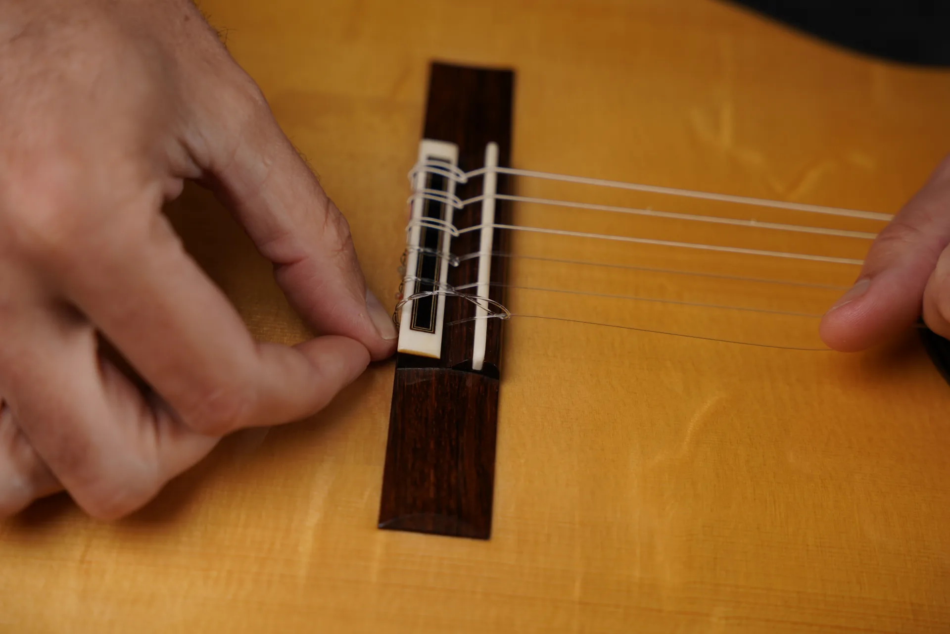 Two loops for nylon strings, three loops for carbon strings