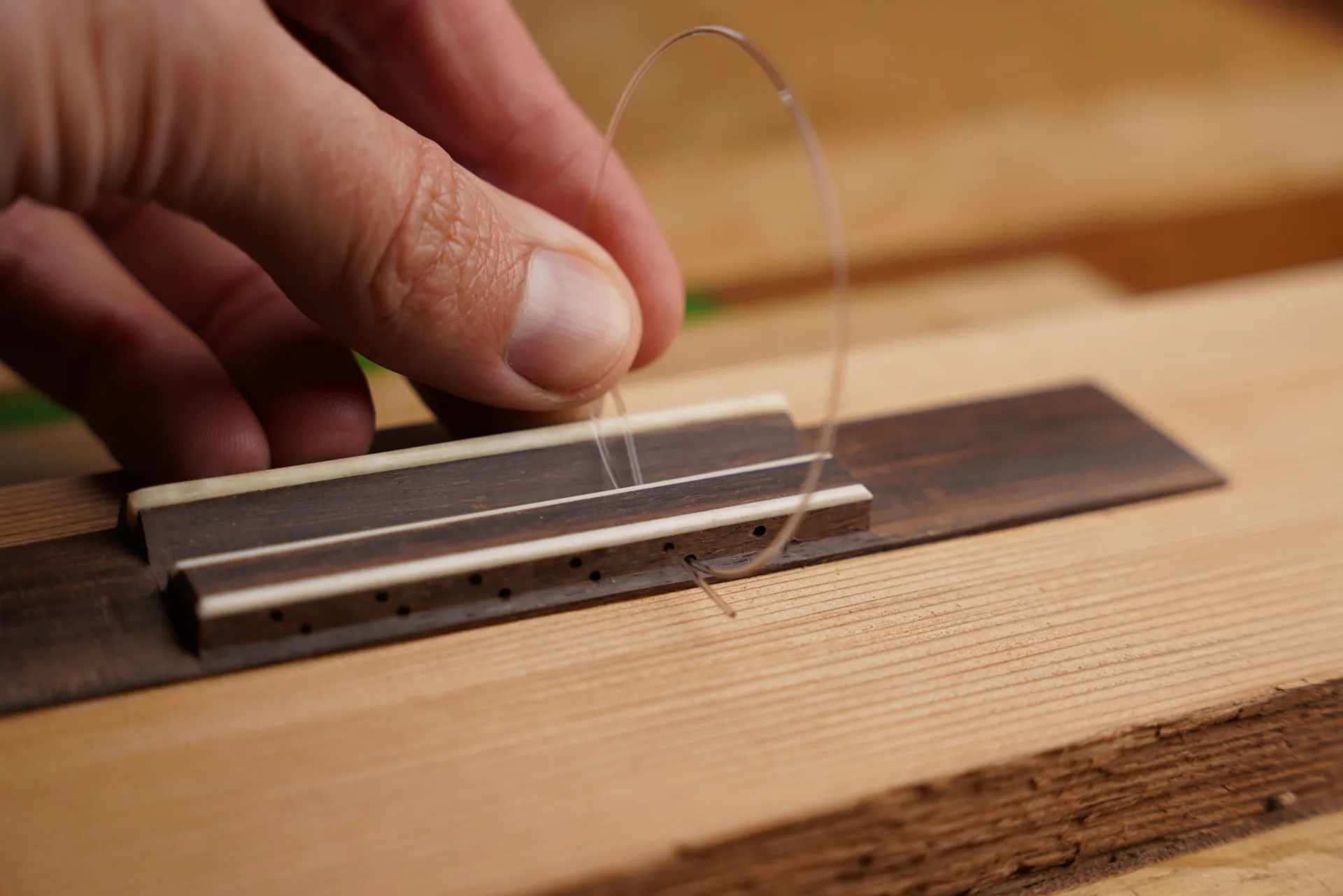 Make a loop and feed the string back through the upper hole