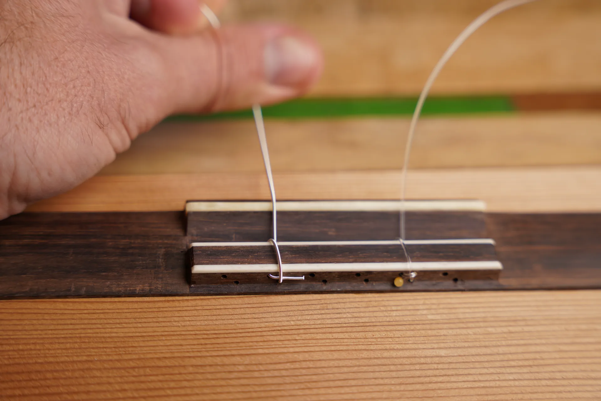 For wound bass strings on a 12-hole bridge, a single loop is sufficient