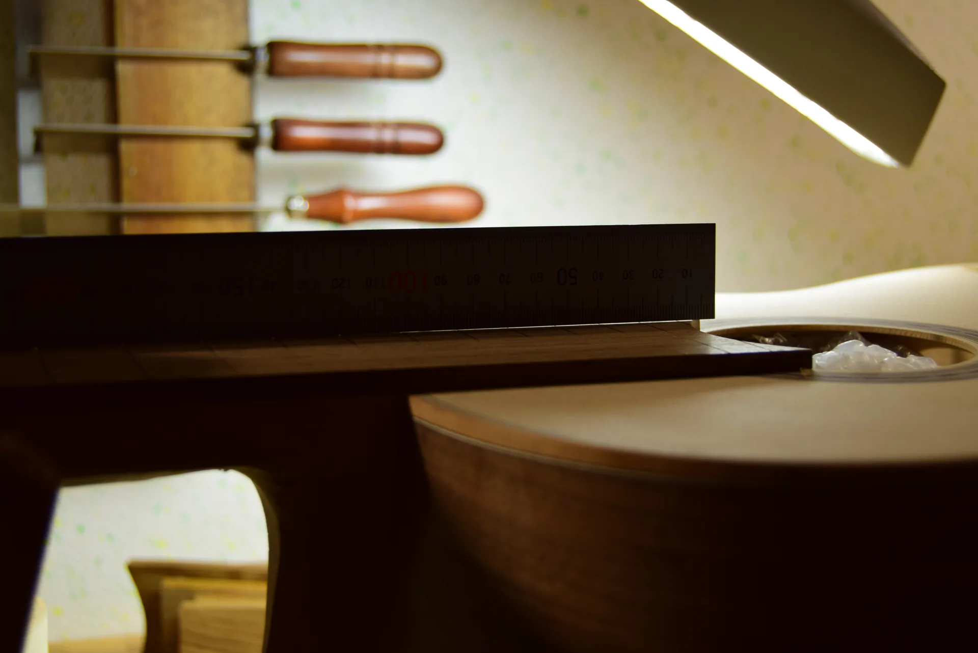 Fall-away created across the fingerboard width after the 12th fret to prevent string buzzing