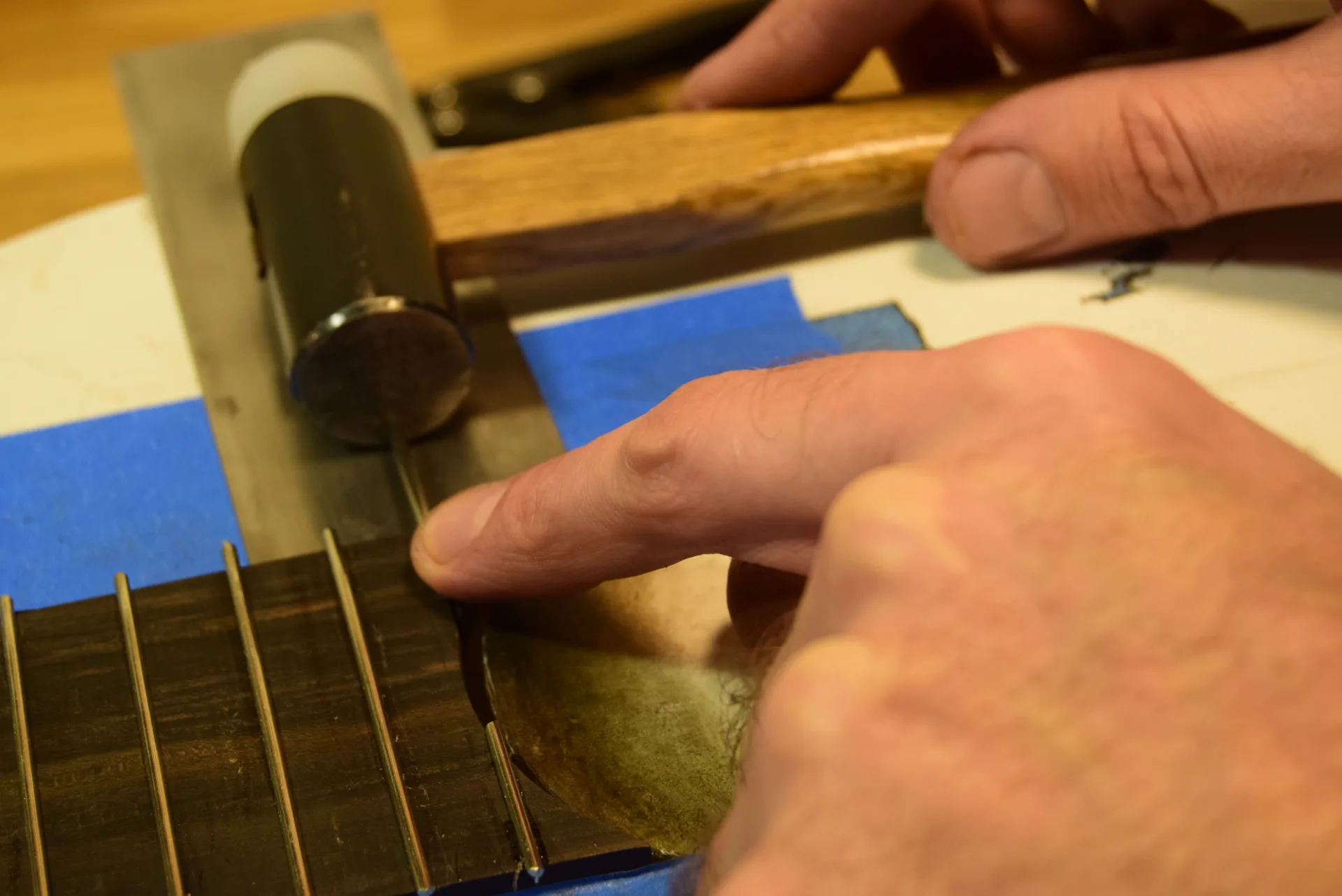The last fret inserted from the side using a hammer