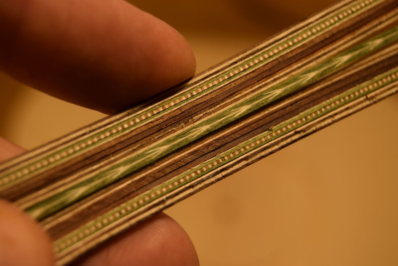 Rosette assembly with clamps pressing the strips into the soundboard channel