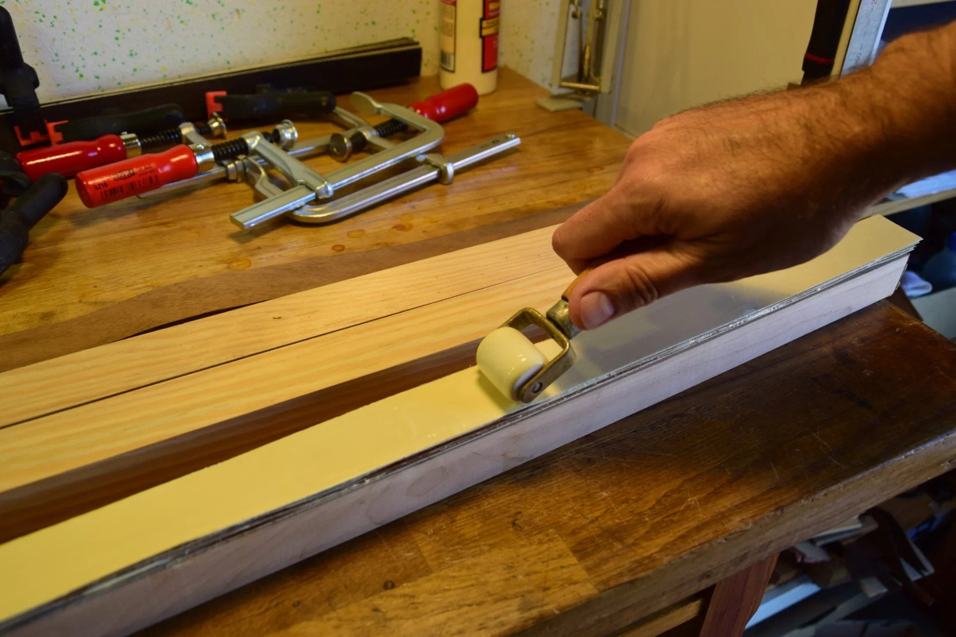 Applying glue with a roller — several separate glue-ups are preferable to one thick stack