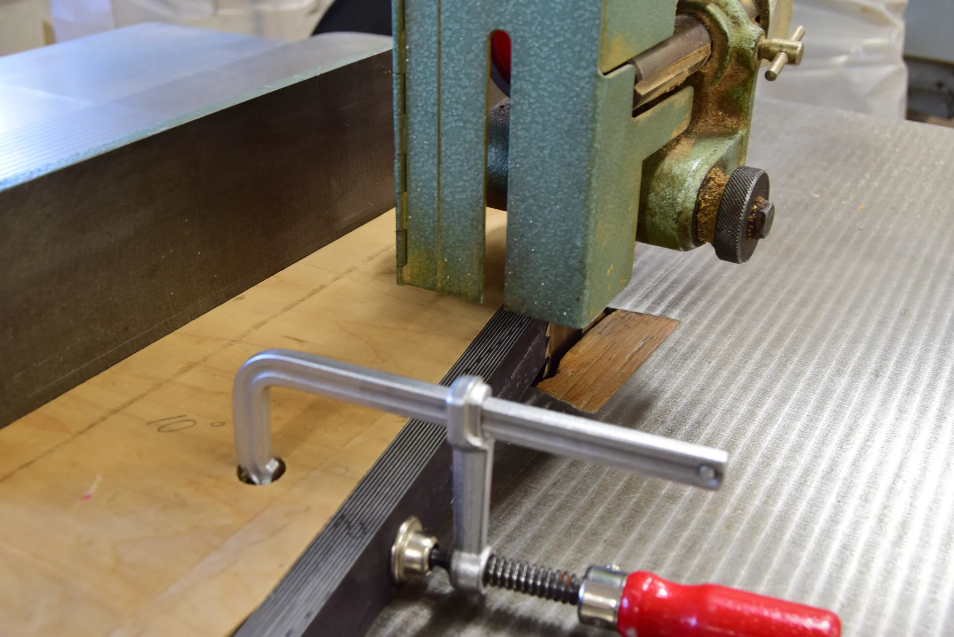 The jig holding the piece securely — cuts made on the band saw at the 10-degree angle