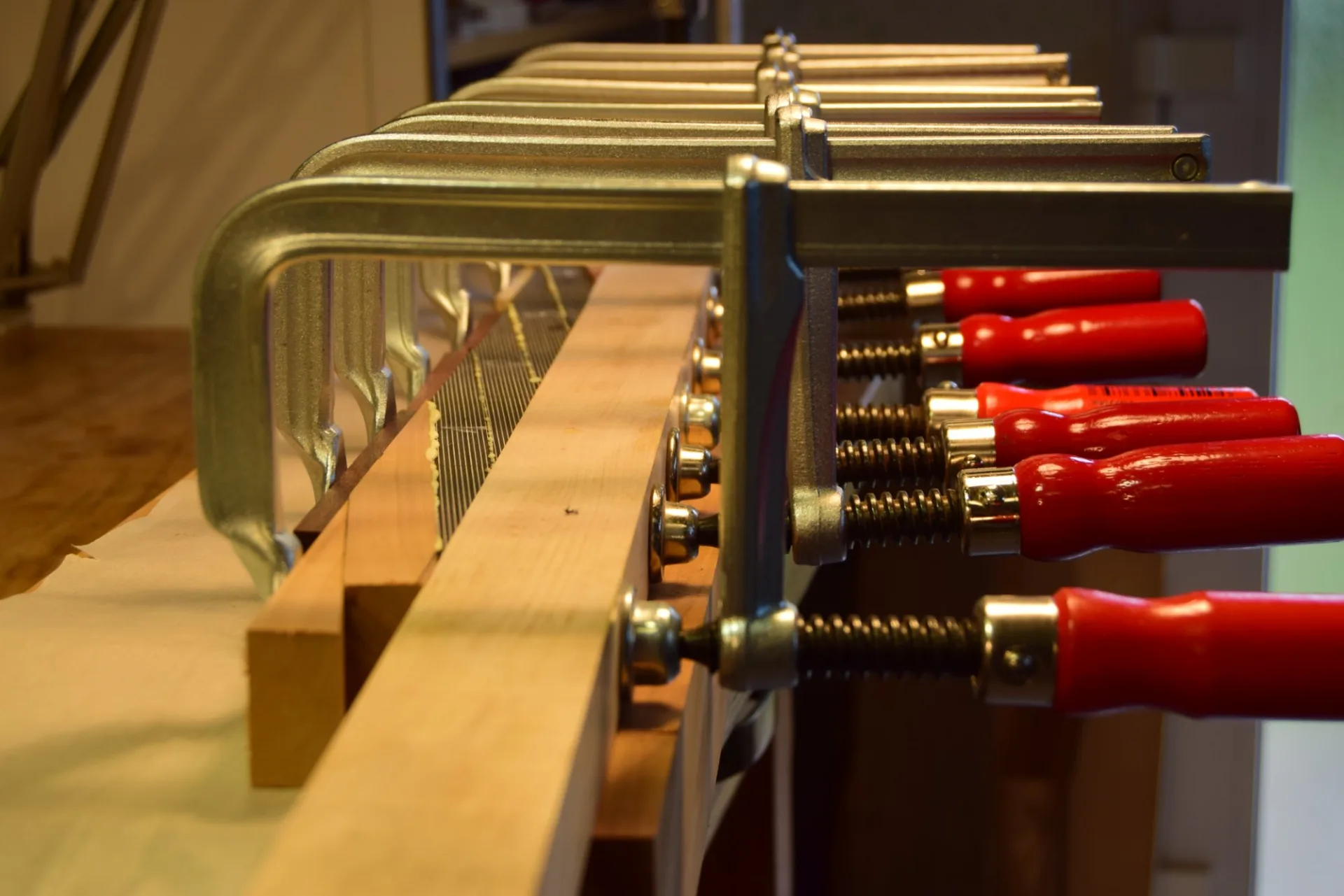 A length of black veneer glued onto each face to maintain the integrity of the piece during thicknessing