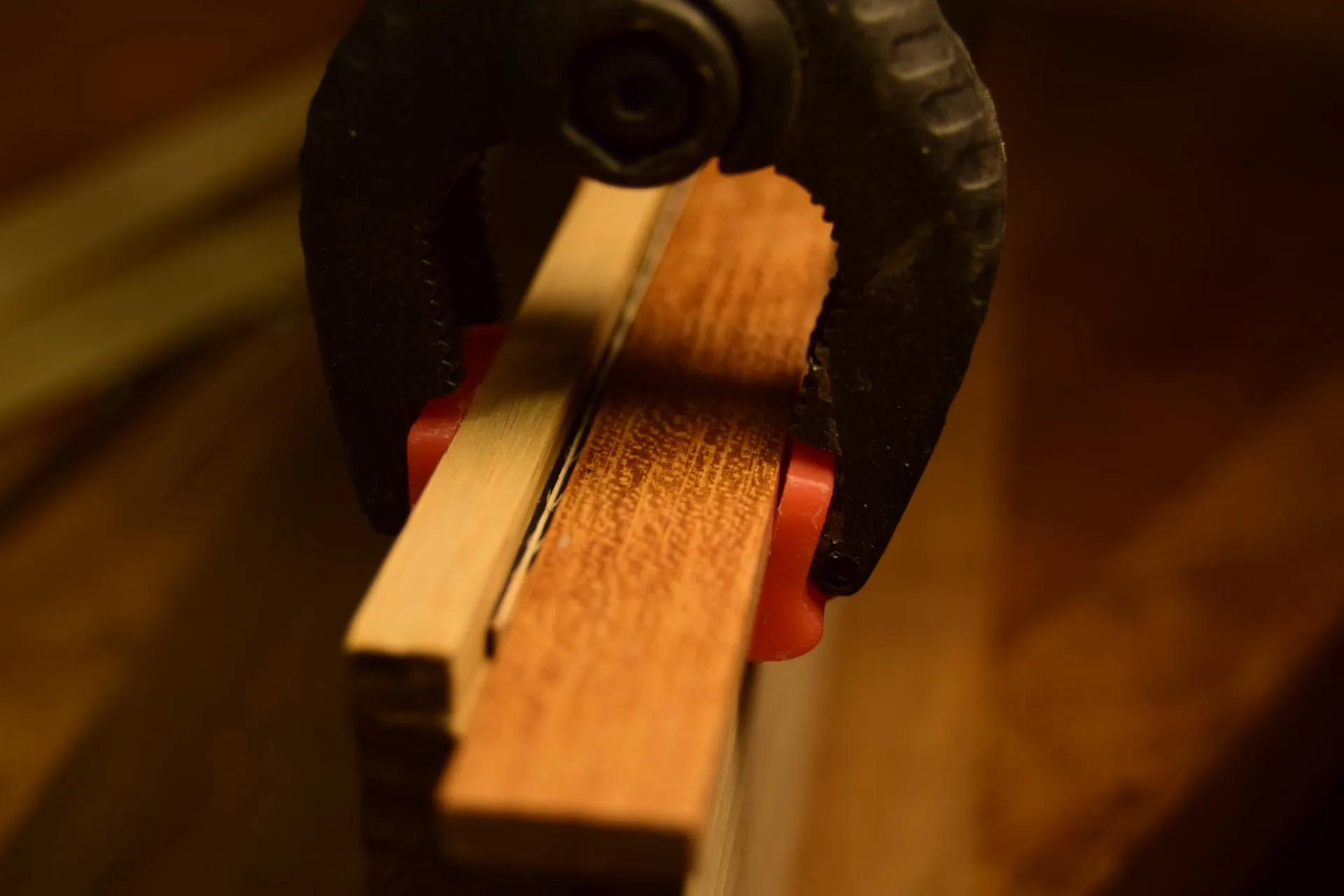 Gluing the assembled herringbone in a groove with a waxed stick and clamps